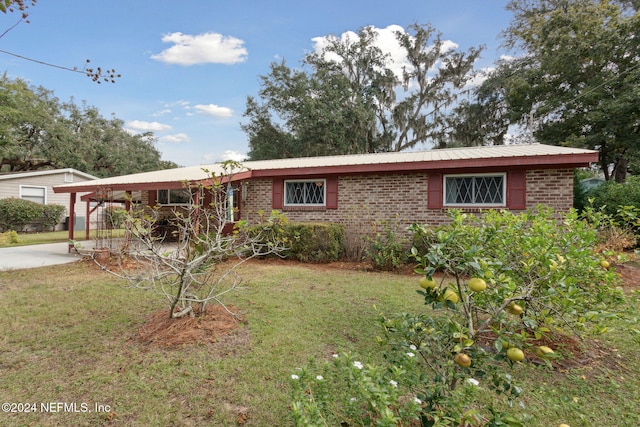 ranch-style house with a front yard and a carport