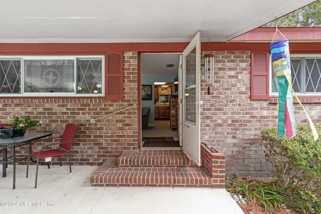 entrance to property with a patio