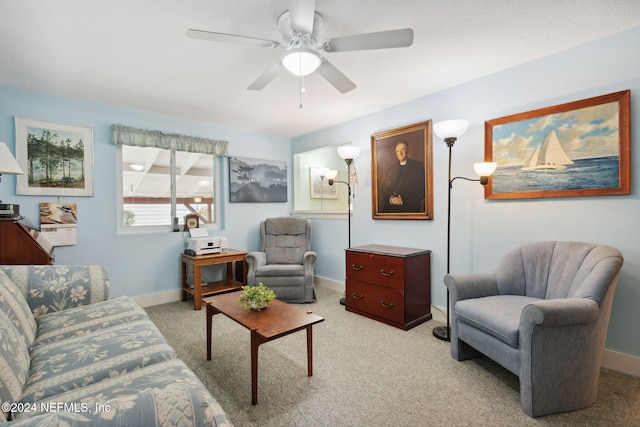 carpeted living room with ceiling fan