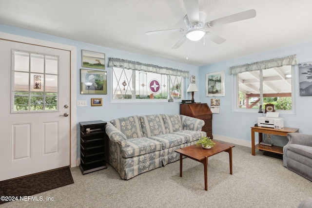 carpeted living room with ceiling fan