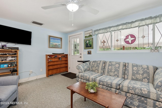 carpeted living room with ceiling fan