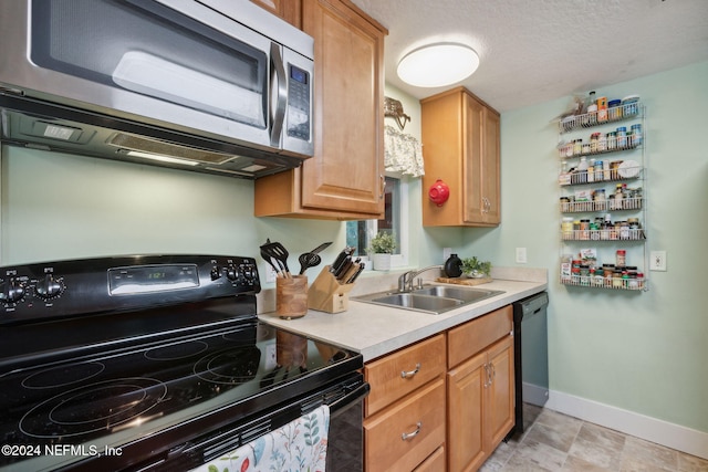 kitchen featuring a textured ceiling, sink, and black appliances