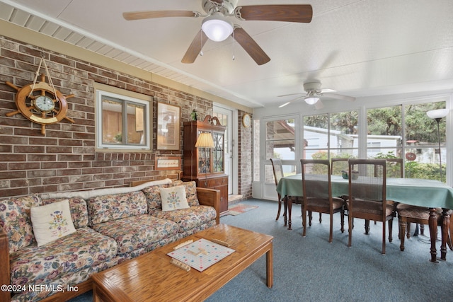 sunroom / solarium featuring ceiling fan