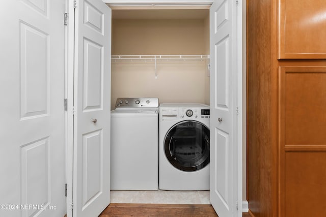 laundry room with tile patterned flooring and separate washer and dryer