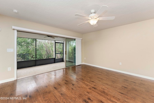 spare room with hardwood / wood-style floors, a textured ceiling, and ceiling fan