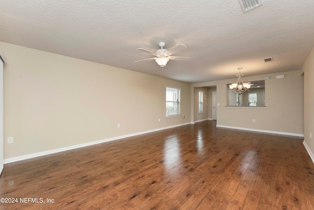 unfurnished room featuring ceiling fan with notable chandelier, a textured ceiling, and dark wood-type flooring