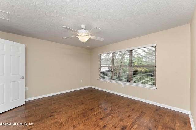 unfurnished room featuring a textured ceiling, ceiling fan, and dark wood-type flooring