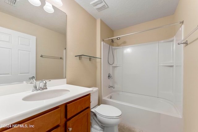 full bathroom featuring washtub / shower combination, vanity, a textured ceiling, and toilet