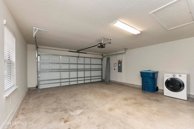 garage with electric panel, washer / dryer, and a garage door opener