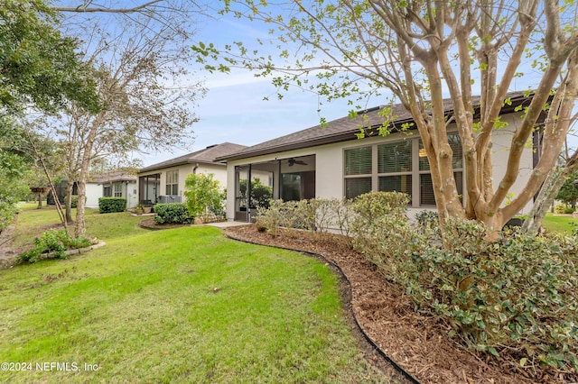 rear view of property featuring a yard