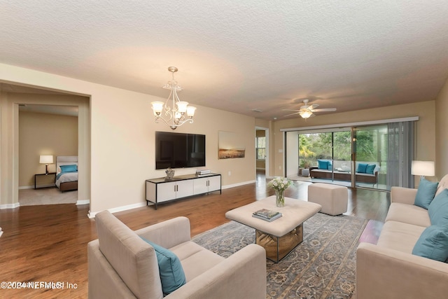 living room with a textured ceiling, ceiling fan with notable chandelier, and hardwood / wood-style flooring