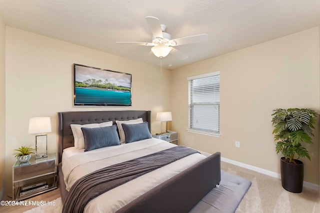 carpeted bedroom with a textured ceiling and ceiling fan