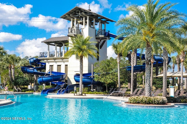 view of pool with a water slide