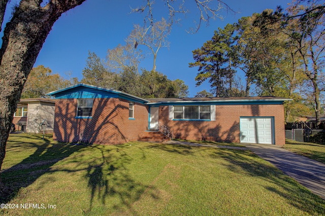 view of front facade with a garage, brick siding, driveway, and a front lawn