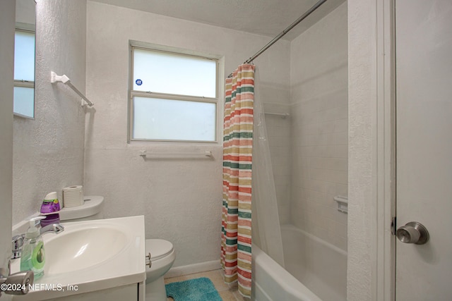 full bathroom with toilet, a textured wall, shower / bath combo, and vanity