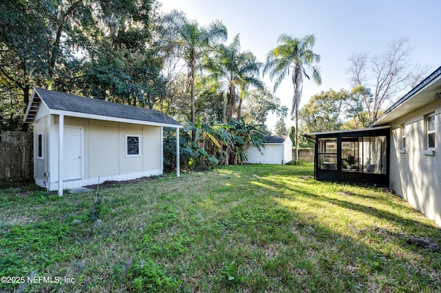 view of yard featuring a sunroom and a shed