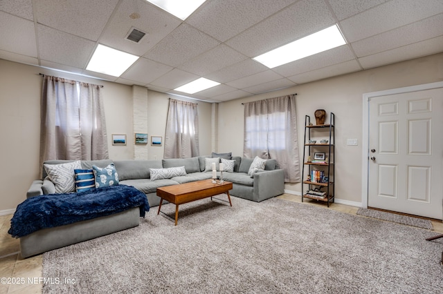 living room featuring a drop ceiling