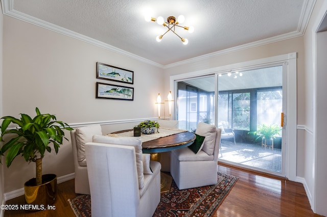 dining area with a notable chandelier, plenty of natural light, a textured ceiling, and dark wood-type flooring