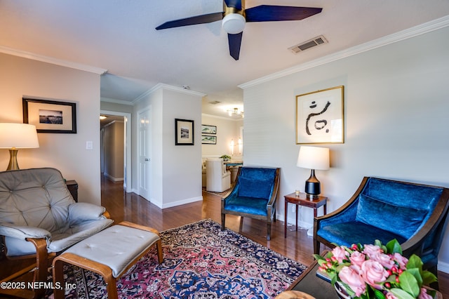 living area featuring dark hardwood / wood-style floors, ceiling fan, and crown molding