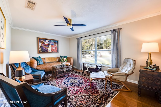 living room featuring ceiling fan, hardwood / wood-style floors, and ornamental molding