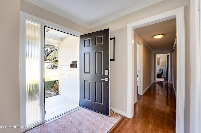 entryway with wood-type flooring and crown molding