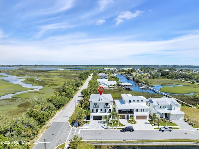 birds eye view of property with a water view and a residential view