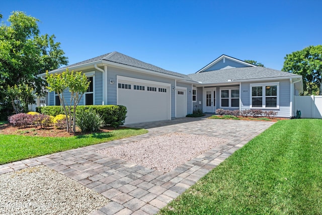 1021 6th Ave N, Jacksonville Beach, FL 32250 - ranch-style house featuring an attached garage, decorative driveway, and roof with shingles