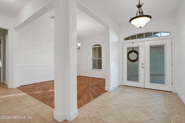 entryway with french doors and light hardwood / wood-style flooring