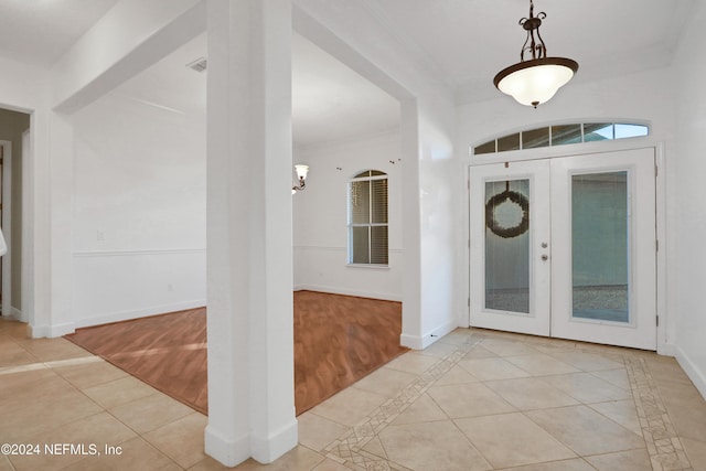 2176 Autumn Cove Cir, Fleming Island, FL 32003 - foyer featuring light tile patterned flooring, crown molding, french doors, and inlaid floor details