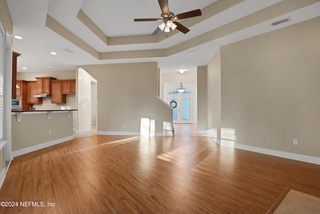 2176 Autumn Cove Cir, Fleming Island, FL 32003 - unfurnished living room featuring a ceiling fan, light wood-type flooring, recessed lighting, and a tray ceiling