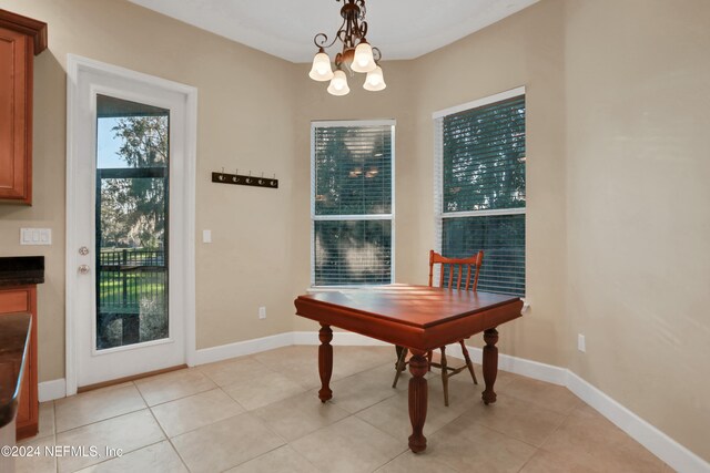 tiled dining area with a notable chandelier