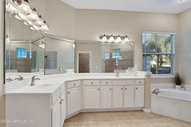 bathroom with tile patterned floors, vanity, and plus walk in shower