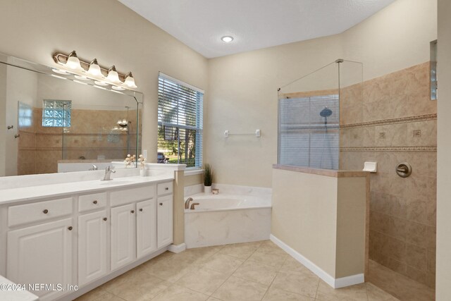 bathroom with tile patterned floors, vanity, and separate shower and tub