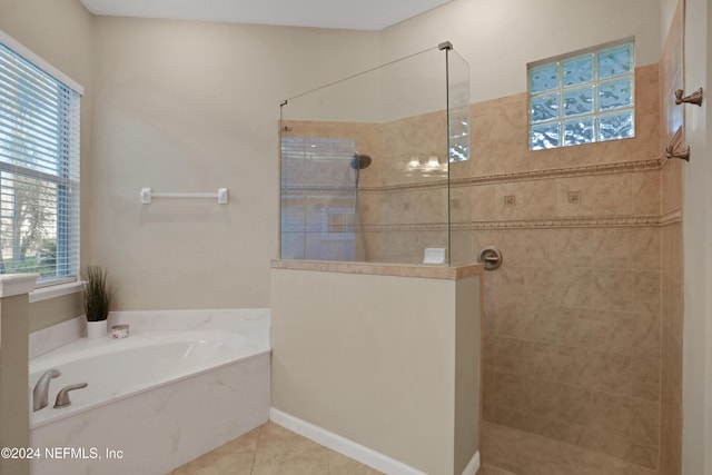 2176 Autumn Cove Cir, Fleming Island, FL 32003 - bathroom featuring a garden tub, walk in shower, and tile patterned floors