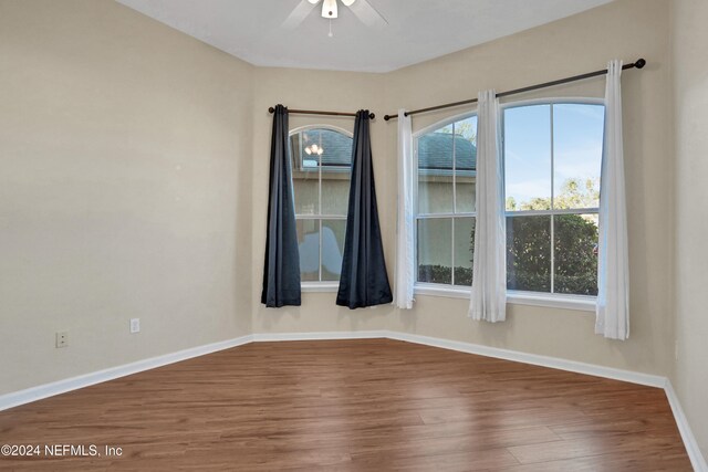 unfurnished room featuring ceiling fan and hardwood / wood-style floors