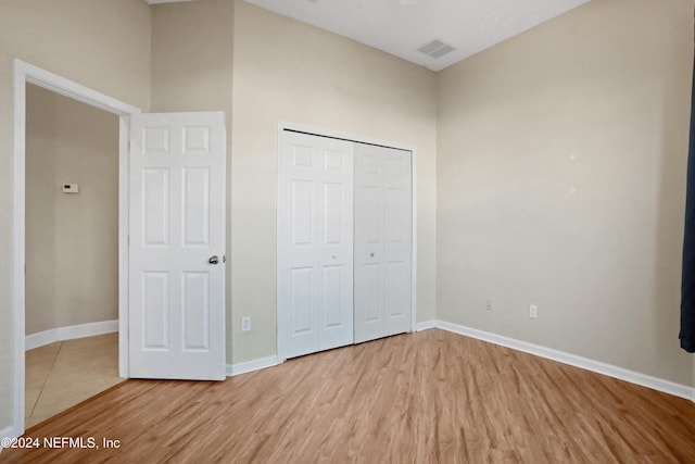 2176 Autumn Cove Cir, Fleming Island, FL 32003 - unfurnished bedroom with light wood finished floors and a closet