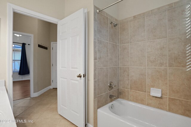 bathroom with tile patterned flooring and tiled shower / bath combo