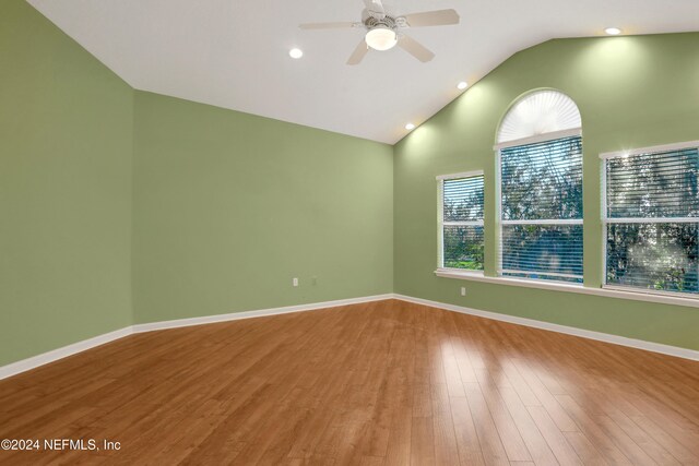 spare room featuring ceiling fan, hardwood / wood-style floors, and vaulted ceiling