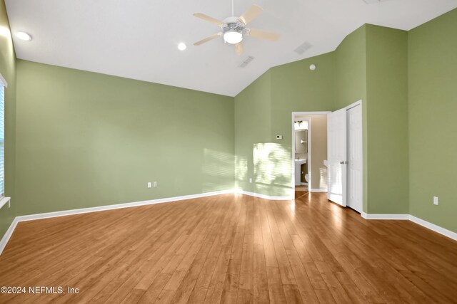 unfurnished bedroom with hardwood / wood-style flooring, high vaulted ceiling, and ceiling fan