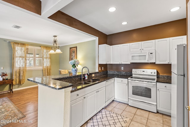 kitchen with kitchen peninsula, white appliances, sink, white cabinets, and light hardwood / wood-style floors