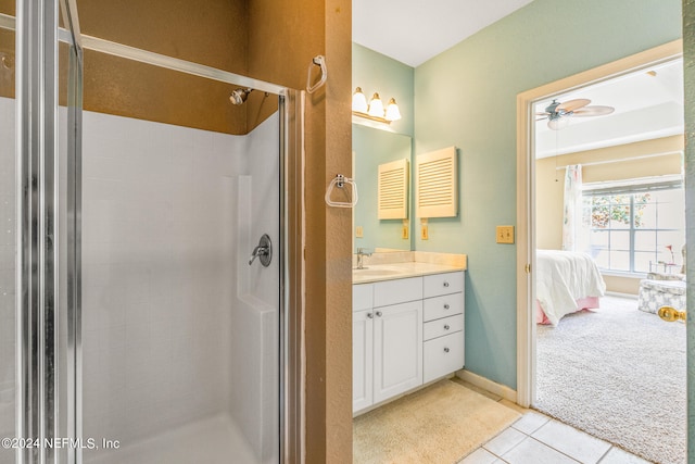 bathroom with tile patterned flooring, vanity, ceiling fan, and walk in shower