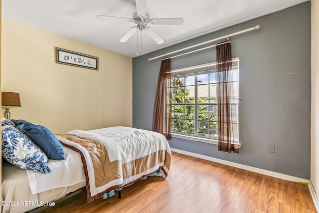 bedroom featuring wood-type flooring and ceiling fan