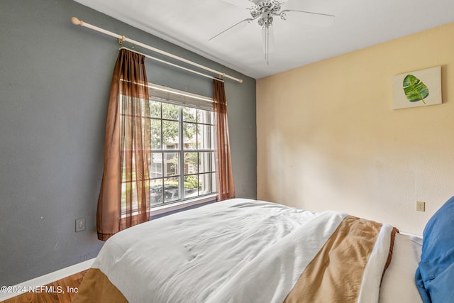 bedroom with hardwood / wood-style flooring and ceiling fan