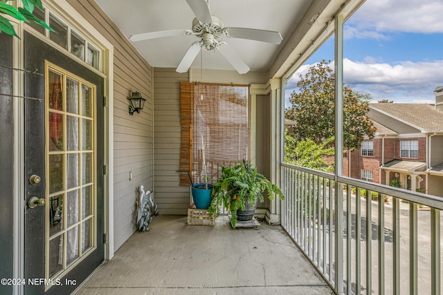 unfurnished sunroom featuring ceiling fan and plenty of natural light