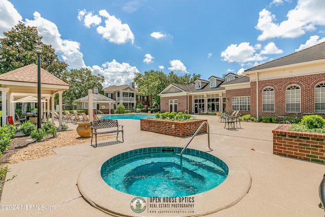 view of swimming pool with a gazebo, a patio, and a hot tub