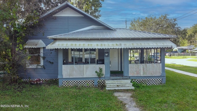 bungalow-style house with covered porch and a front lawn