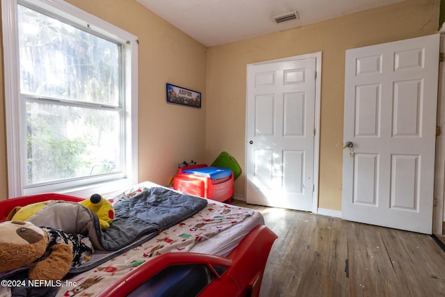 bedroom with hardwood / wood-style flooring