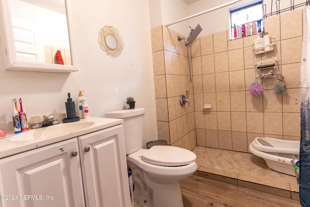 bathroom with walk in shower, toilet, vanity, and hardwood / wood-style flooring