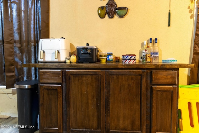 bar with dark brown cabinetry