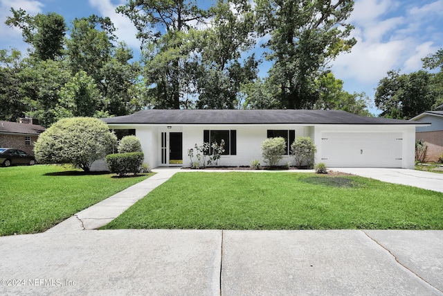 ranch-style house featuring a garage and a front yard